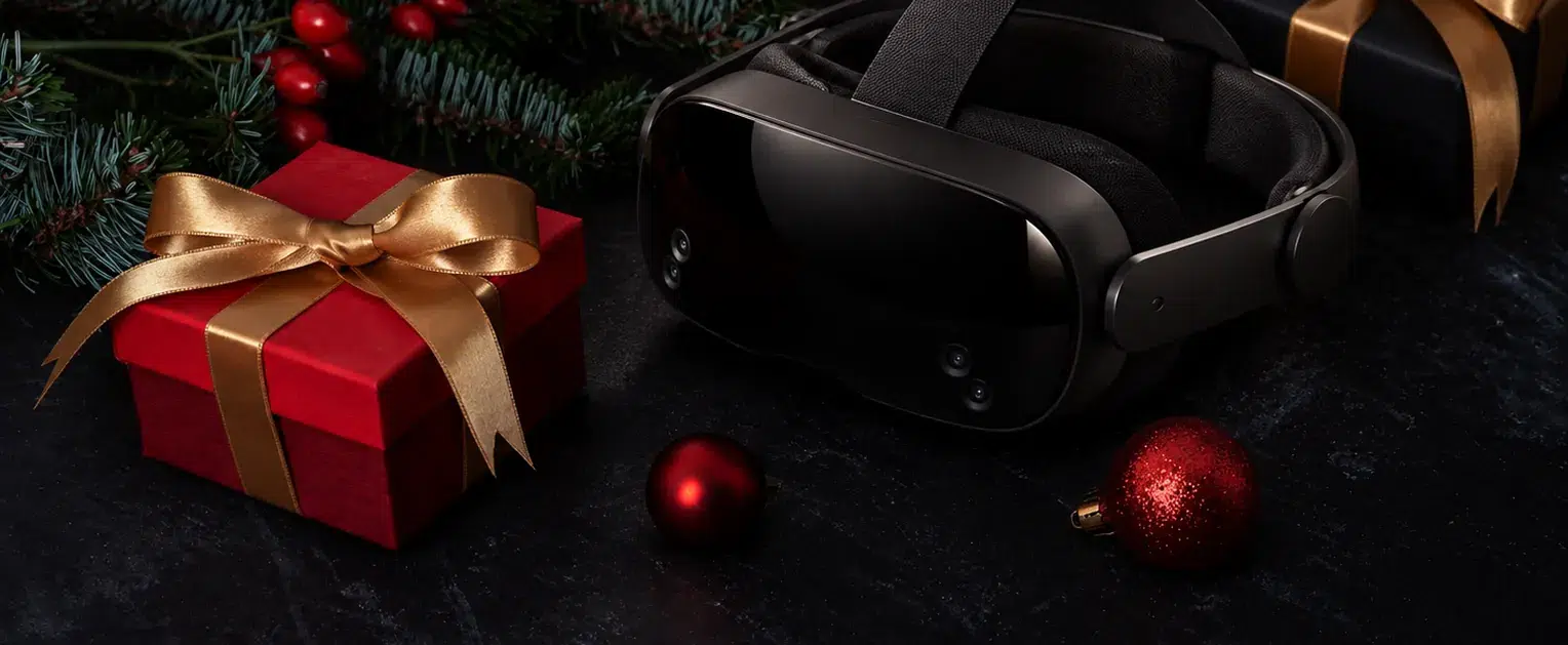 Casque de réalité virtuelle entre deux cadeaux à rubans dorés et des branches de sapin : idées cadeaux de Noël originales à Paris